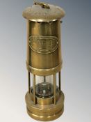A Thomas & Williams Limited brass miner's safety lamp.