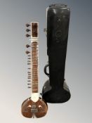A sitar, length 122 cm, in hard carry case.