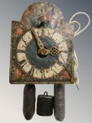 An early 20th century wall clock movement with painted dial and weights.