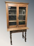 A 19th century pine double door cabinet, width 109 cm, together with a single drawer side table.