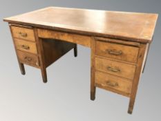 A 1930's oak twin pedestal desk, 152 cm x 86 cm x 77 cm.