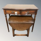 A reproduction mahogany side table and a small oak drop leaf table.