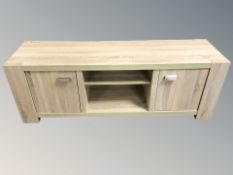 A modern laminated low entertainment stand, 143 cm x 40 cm x 50 cm.
