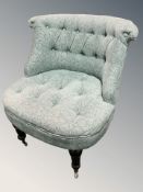 A modern armchair in buttoned blue upholstery