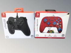 Two Nintendo Switch controllers in boxes.