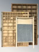 A pine and galvanised metal washboard and two type trays.