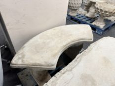 A concrete curved squirrel bench.