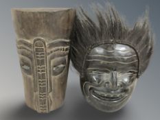 An Indonesian carved wood and hair tribal mask together with West African carved mask