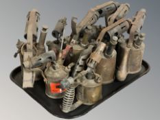 A group of antique brass blow torches.