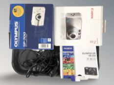 Three digital cameras by Olympus and Canon