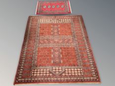 A machine-made rug of Turkoman Ensari design, 170cm by 144cm, together with a further rug.