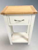 A contemporary single drawer bedside stand with oak top, width 45 cm.