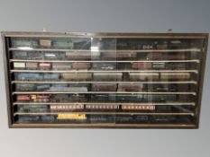 A display case with sliding perspex panel doors displaying a large quantity of model railway