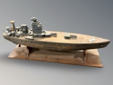 A vintage wooden military battleship on stand,