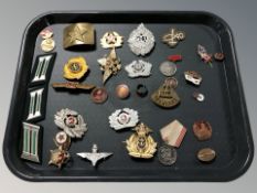 A group of reproduction Soviet badges, various other insignia, belt buckle, etc.