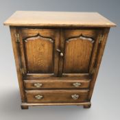 A contemporary oak entertainment cabinet fitted with two drawers, width 95 cm.