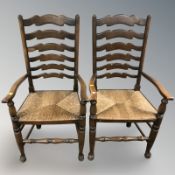 A pair of Titchmarsh & Goodwin oak ladder back rush seated armchairs.
