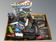 A box containing die cast locomotives and model cars, Thomas the Tank Engine, military vehicles.