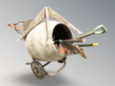 A cement mixer and a quantity of tools.