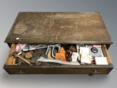 A 1920's oak three drawer chest containing a large quantity of tools.
