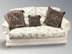 A contemporary two tone grey cloth two seater settee.