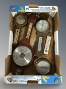 A group of contemporary oak barometers.