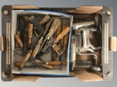 A box containing a group of woodworking chisels and vintage tools.