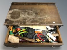 A 1920's oak three drawer chest containing a large quantity of tools.