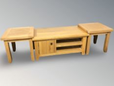 A pair of light oak lamp tables, width 50 cm, together with a further matching entertainment unit.