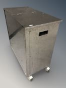 A stainless steel twin-lidded bin,