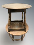 A reproduction oak circular occasional table, diameter 75 cm.