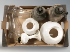 A box of glass light shades and copper lamps etc