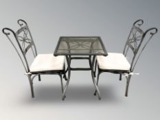 A metal garden patio table and pair of chairs.