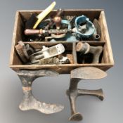 A wooden box containing tools, hand tools, brushes,