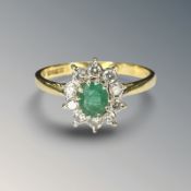 An 18ct gold emerald and diamond cluster ring, size P½ CONDITION REPORT: 2.