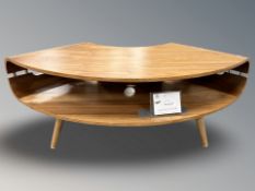 A contemporary curved laminated teak entertainment stand, width 130 cm.