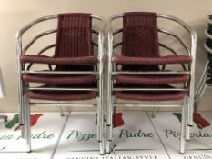 A stack of six red tubular steel chairs