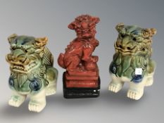A pair of Chinese foo dogs and an oriental ornament