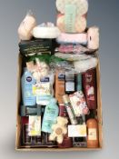 A box containing un-used skin care products, soap, After-sun,