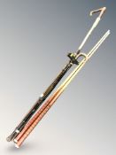 A group of sticks, a walking stick and two snooker cues including an antique swordstick.