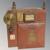 An antique metal gas meter.