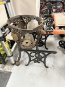 A cast iron table base, together with a further table base.