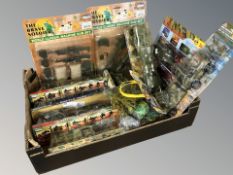 A box containing friction powered military vehicles, kit figures, etc.