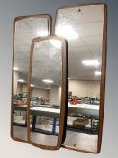 Three teak-backed 1970's mirrors, each approximately 32 cm x 92 cm.