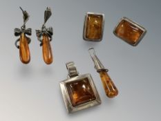 A pair of silver amber earrings with matching pendant together with similar earrings and pendant.