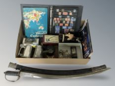 An Indian style sword in sheath, cast iron money box, stamp album,