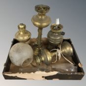 A group of brass paraffin lamps with etched glass shade and two glass chimneys.