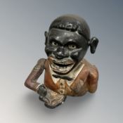 An early 20th century cast iron mechanical money box.