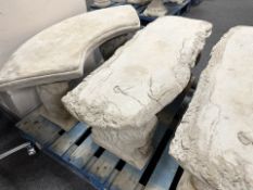 A concrete pedestal bench with scroll base.