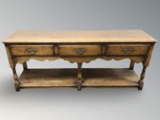 A Titchmarsh & Goodwin oak three drawer dresser base in the George III style, width 184 cm.